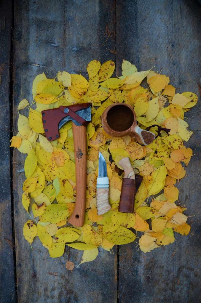 Finnish hiking tools on a table of leaves